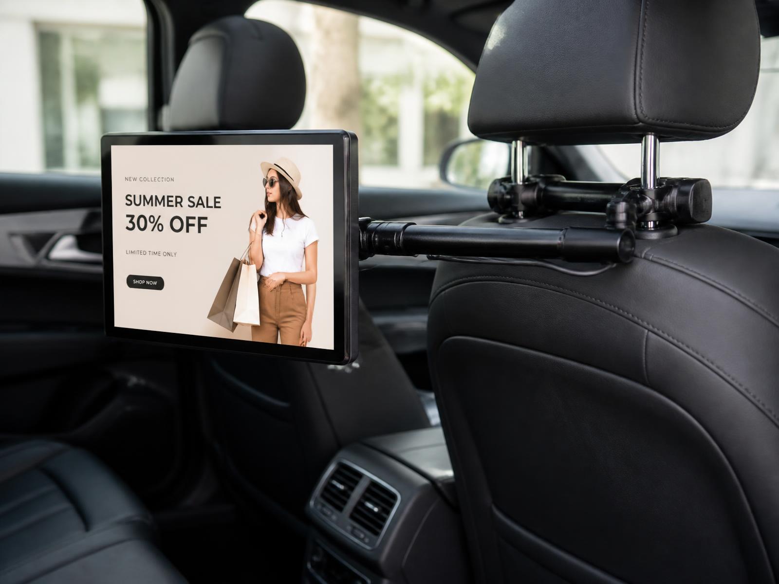 Headrest-mounted 10.1 inch in-cab advertising screen displaying a retail campaign